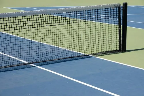 Close-up of a tennis netting installation on a well-maintained court,