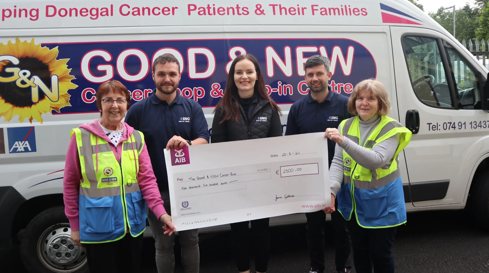 The team from SNG presenting a cheque to the good and new cancer bus in Letterkenny