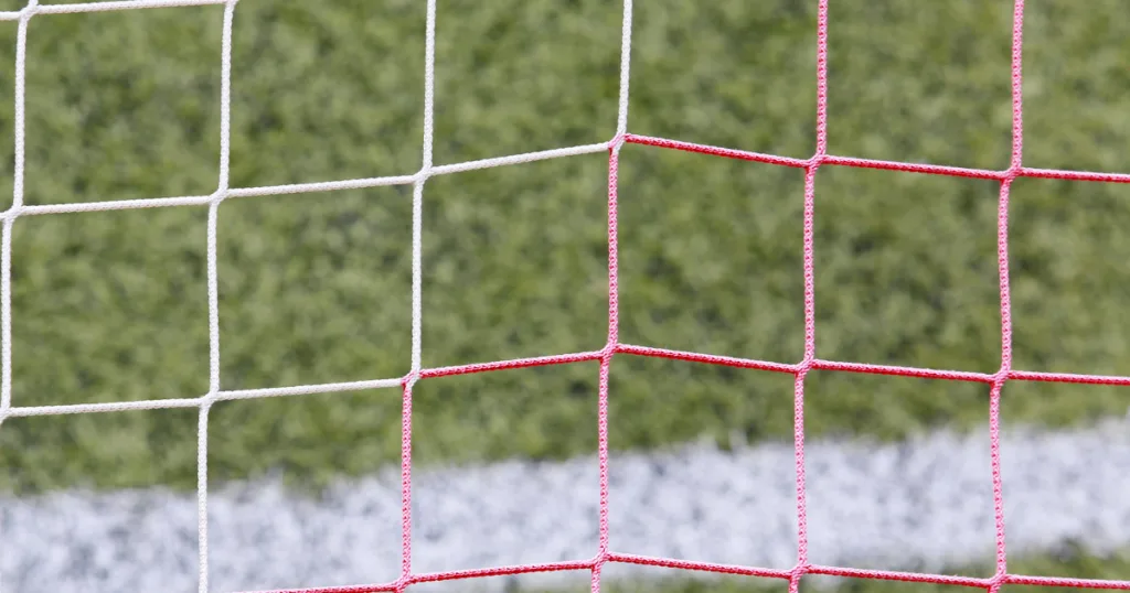 Close-up of goal post nets in vibrant club colours, highlighting SNG Sports Nets' commitment to enhancing visual identity.