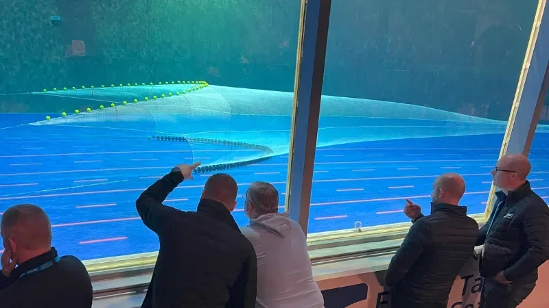 the SNG team assessing a model net’s performance in the flume tank during water flow testing.