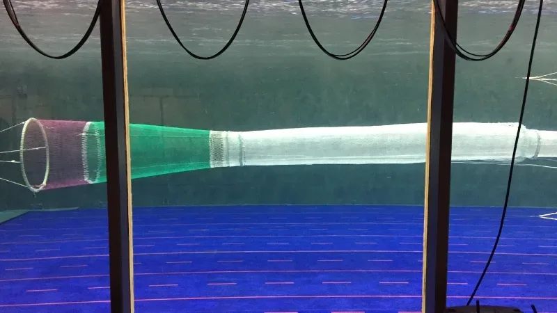 Scaled Fishing nets secured in a flume tank to measure water flow and strength